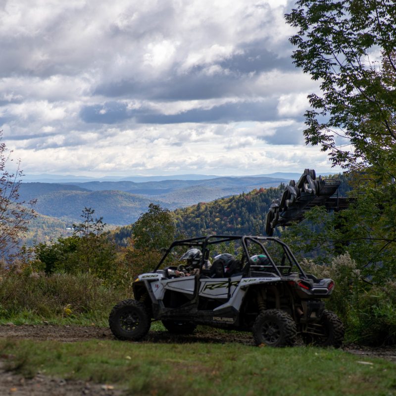a truck is parked on the side of a hill