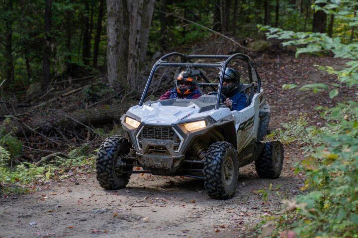 a truck driving down a dirt road
