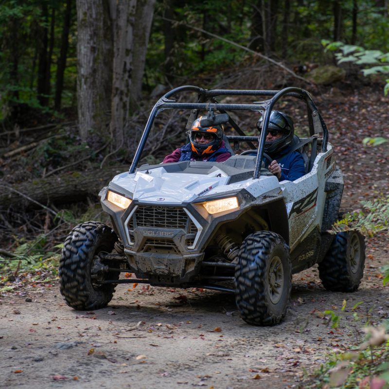a truck driving down a dirt road